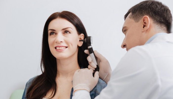 woman-smiling-at-her-professional-hearing-examination woman-smiling-at-her-professional-hearing-examination
